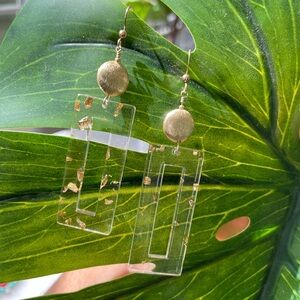 Lucite open rectangular shape with gold flecks. Pierced earrings